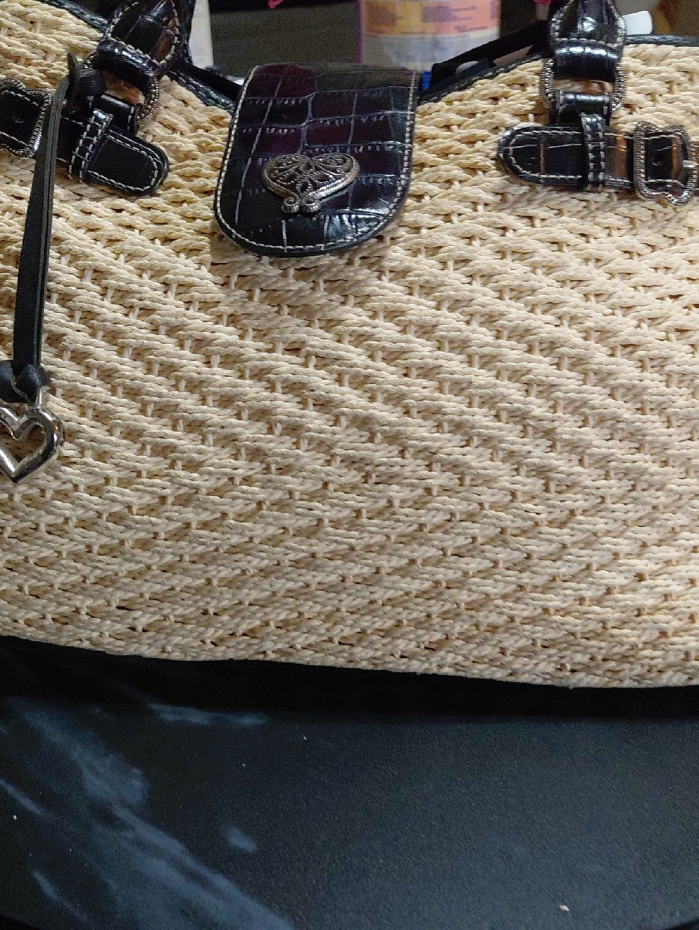 This item is a Brighton brand shoulder tote bag featuring a woven straw body